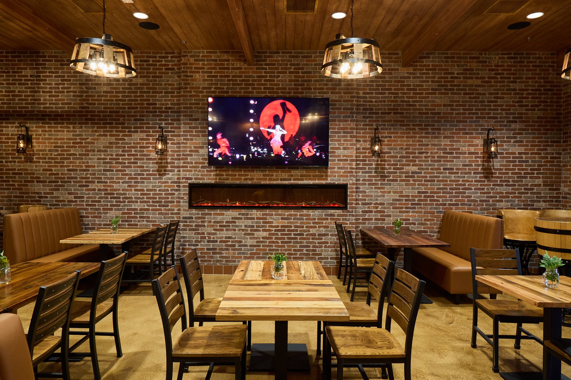Alps Village’s private dining room with wood tables, brick walls, and a fireplace